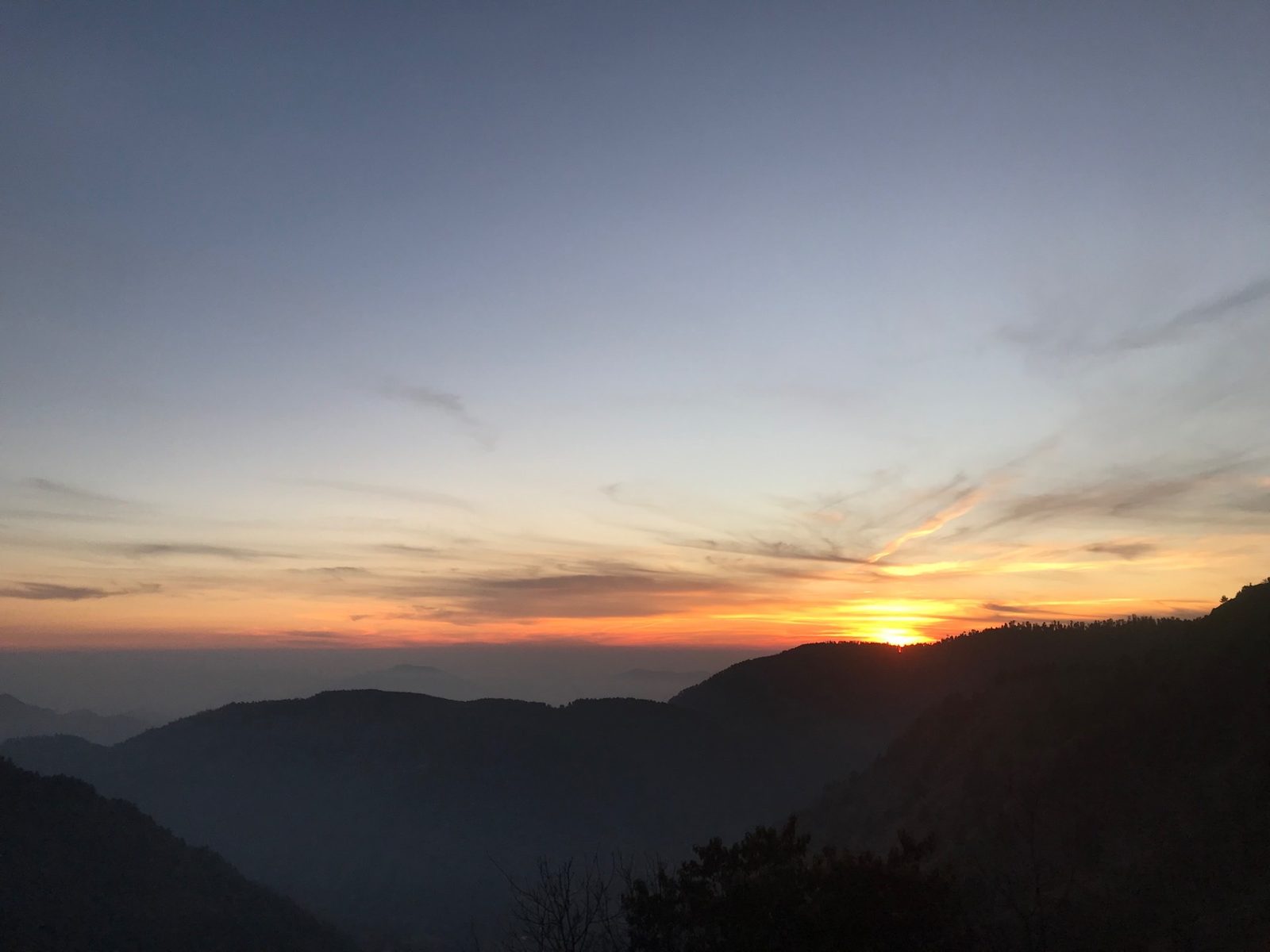 Sunset over the mountain ranges seen from Sattu Bungalow